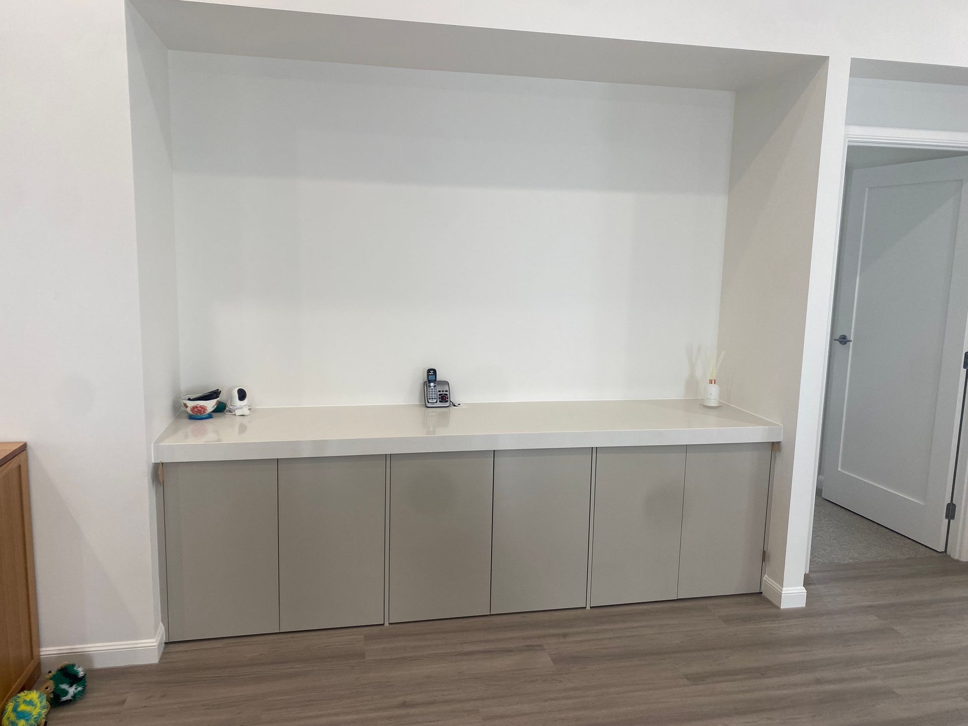 A living room with a built in entertainment center and a white wall — Coastal Detail Joinery in Tuncurry, NSW