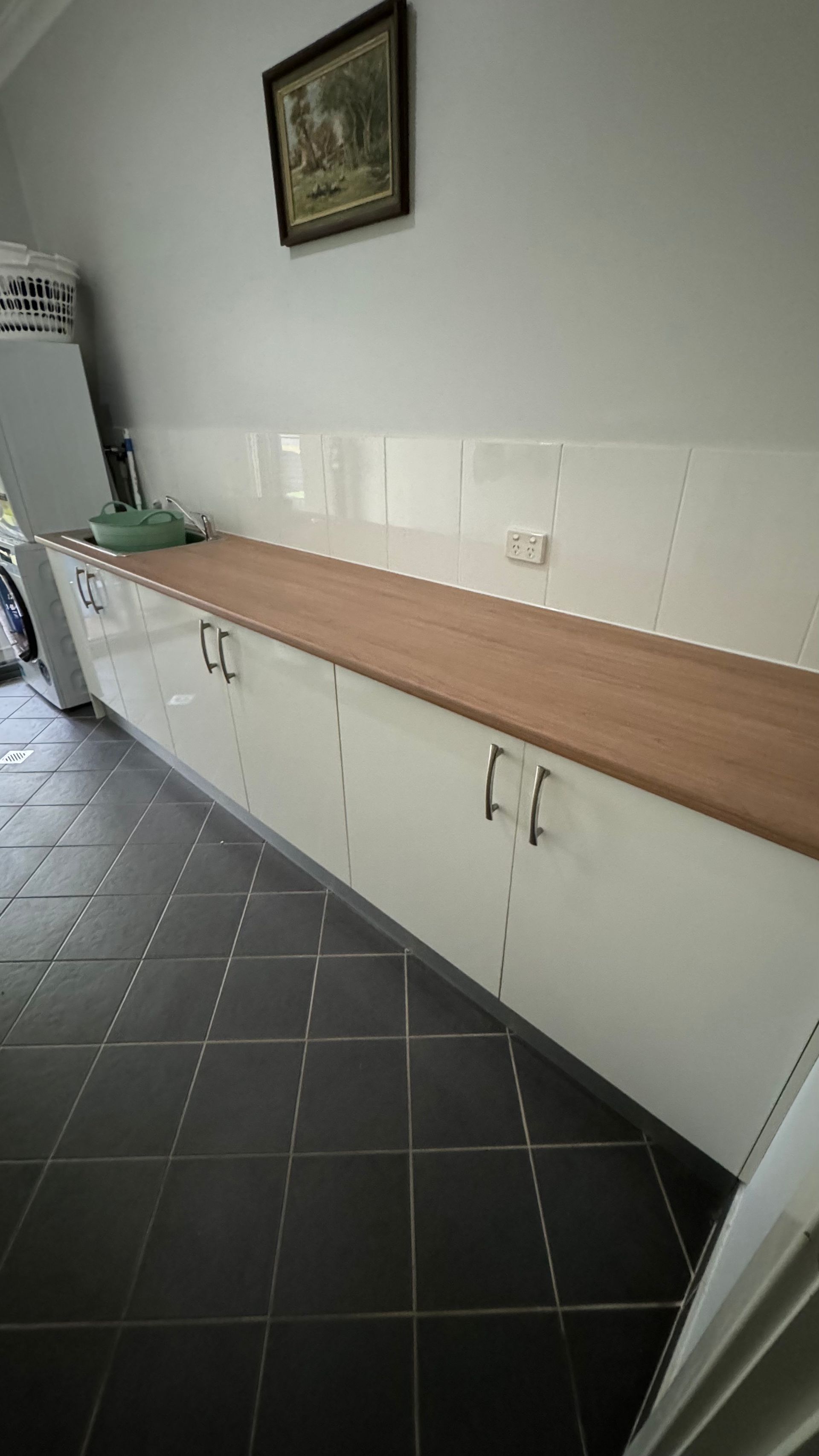 A kitchen with white cabinets and a wooden counter top — Coastal Detail Joinery in Tuncurry, NSW