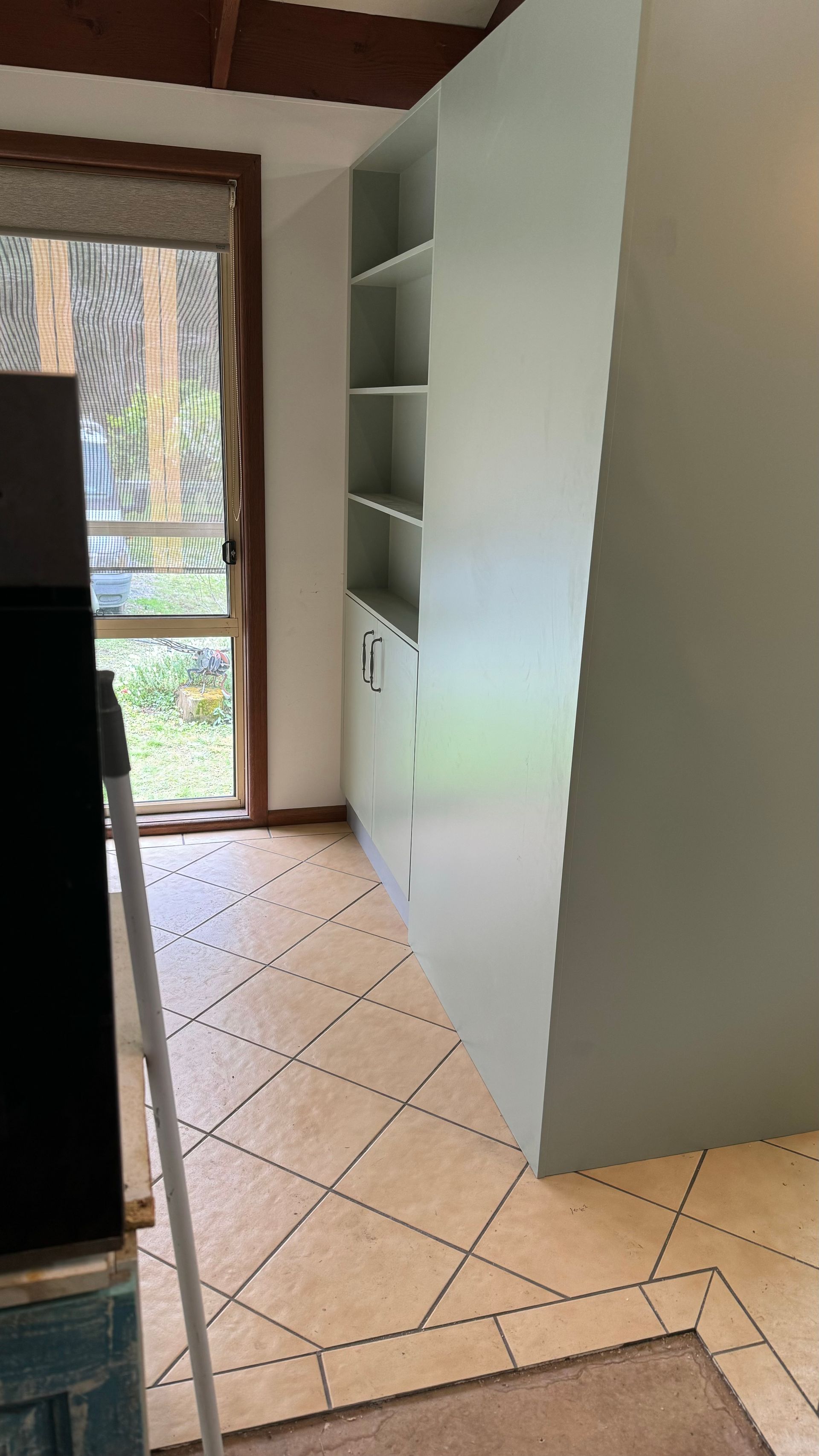 A room with a tiled floor, a shelf, cabinets and a window — Coastal Detail Joinery in Tuncurry, NSW