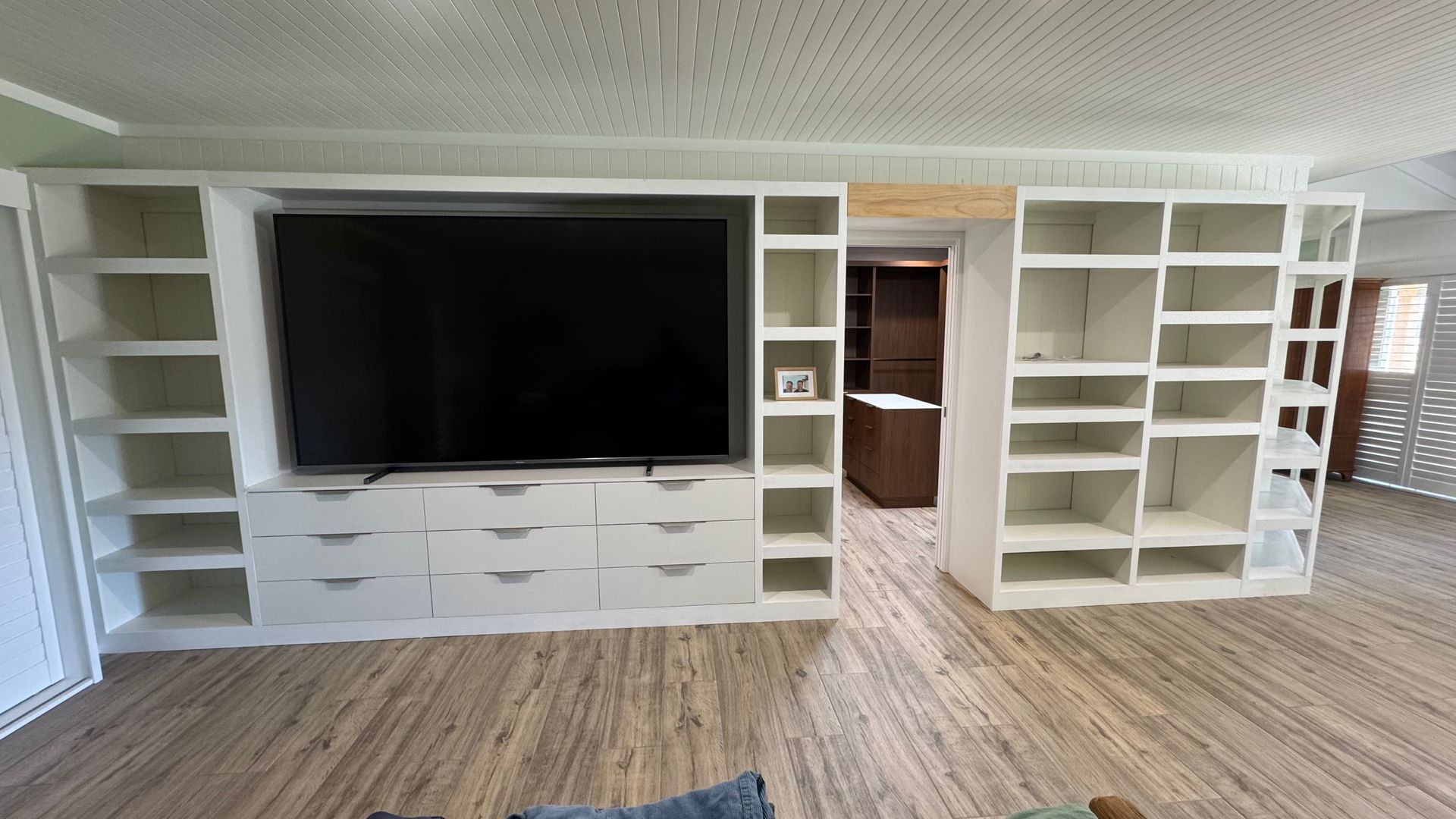 A living room with lots of shelves and a flat screen tv — Coastal Detail Joinery in Tuncurry, NSW