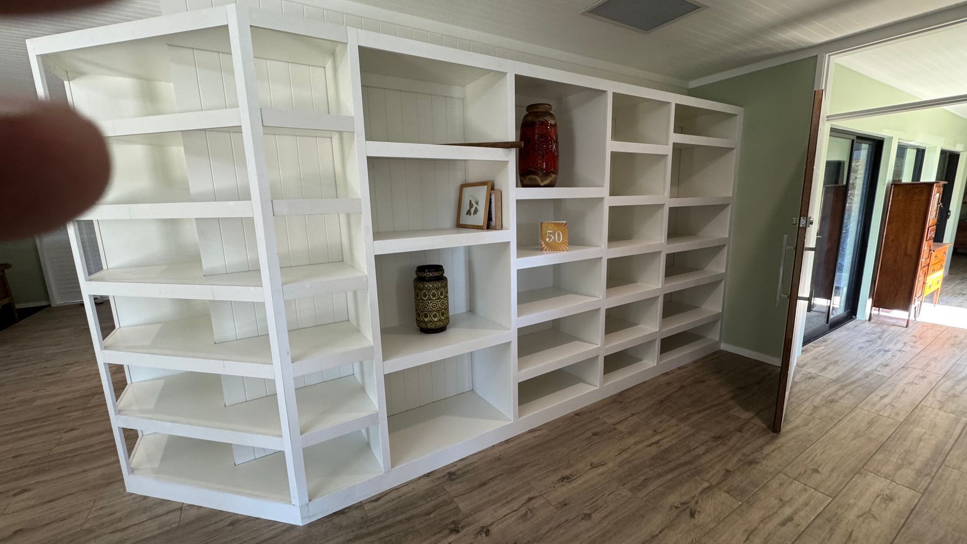 A room with a lot of white shelves and a wooden floor — Coastal Detail Joinery in Tuncurry, NSW