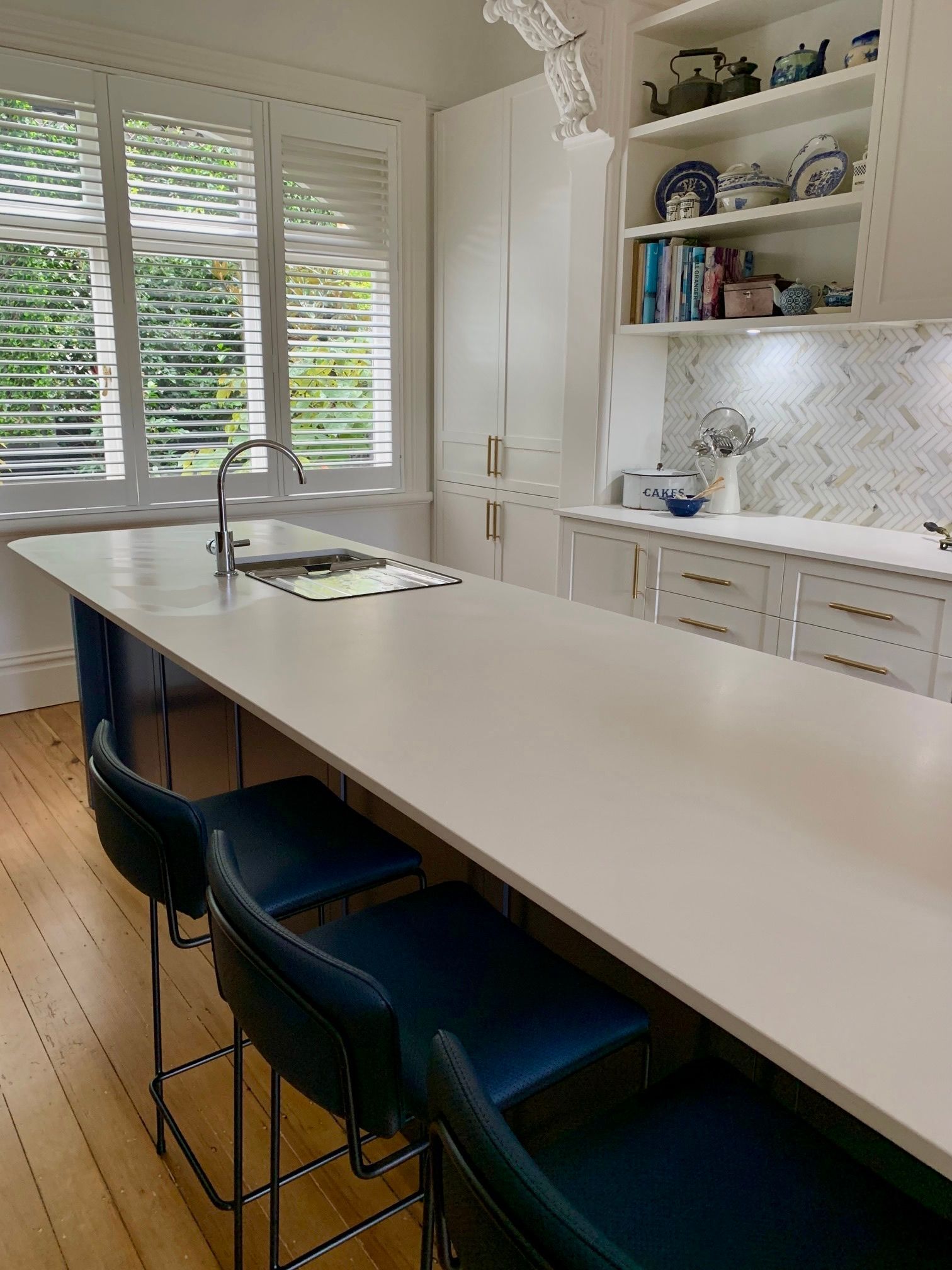 A kitchen with a large island and stools — Coastal Detail Joinery in Tuncurry, NSW