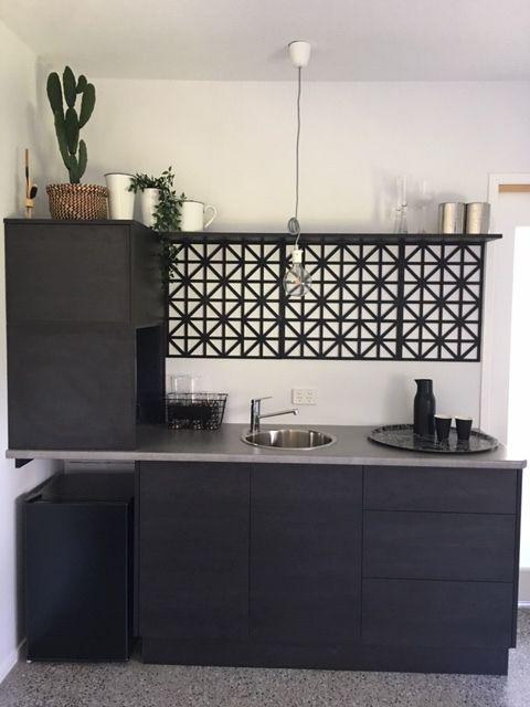 A Kitchen With Black Cabinets and a Sink — Coastal Detail Joinery in Tuncurry, NSW