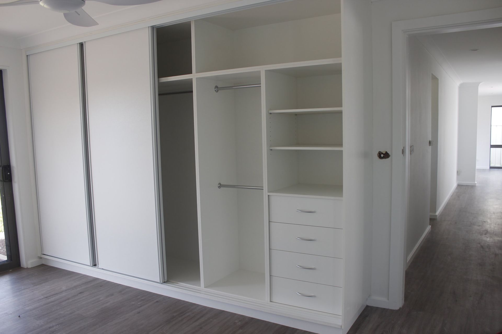 A White wardrobe and Drawers and sliding doors — Coastal Detail Joinery in Tuncurry, NSW