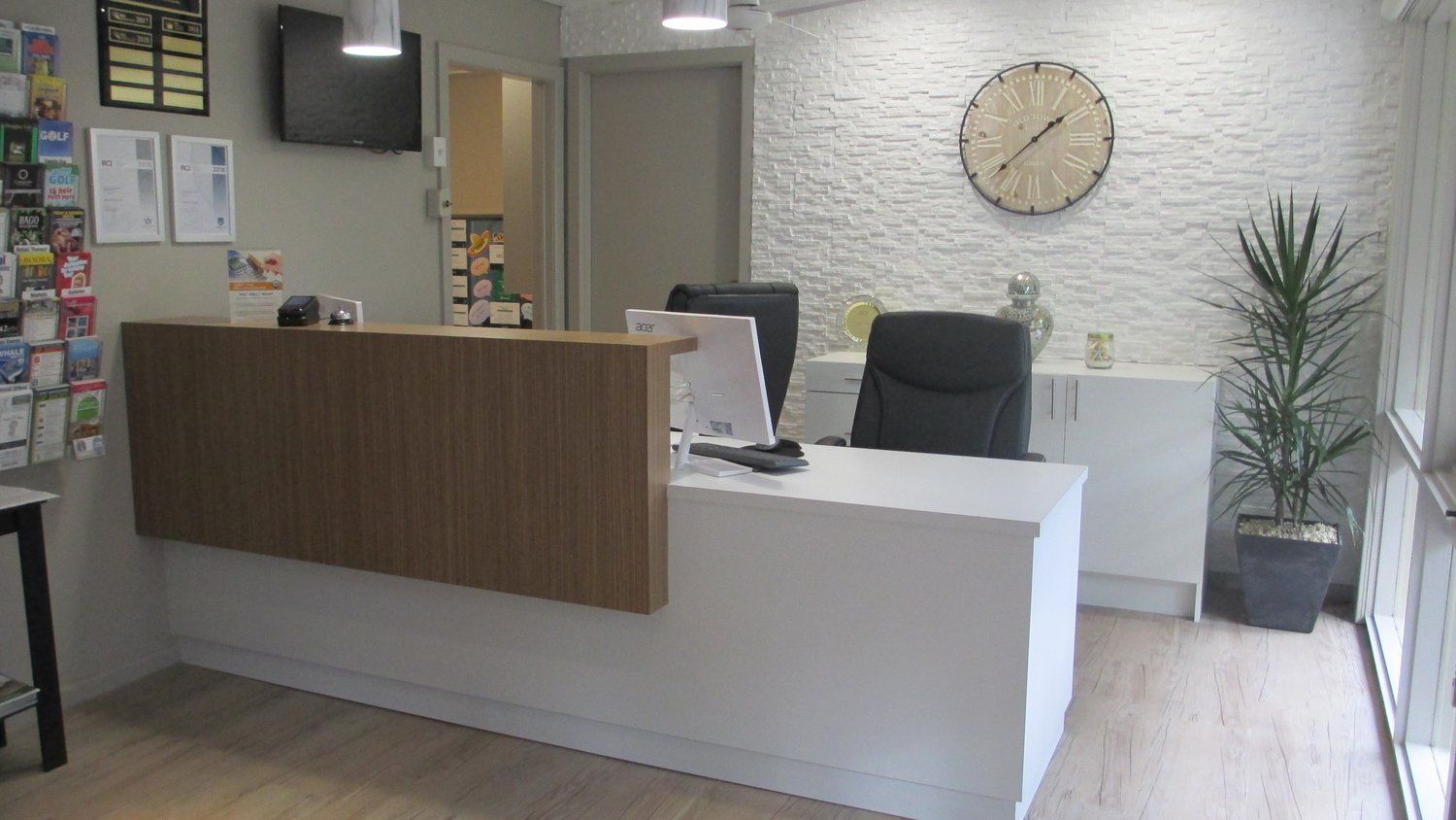A Reception Area With a Clock on the Wall and a Desk — Coastal Detail Joinery in Tuncurry, NSW