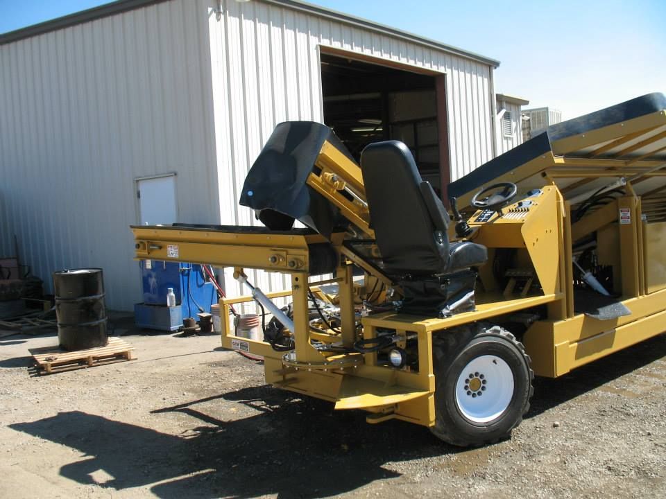 a yellow truck is parked in front of a white building