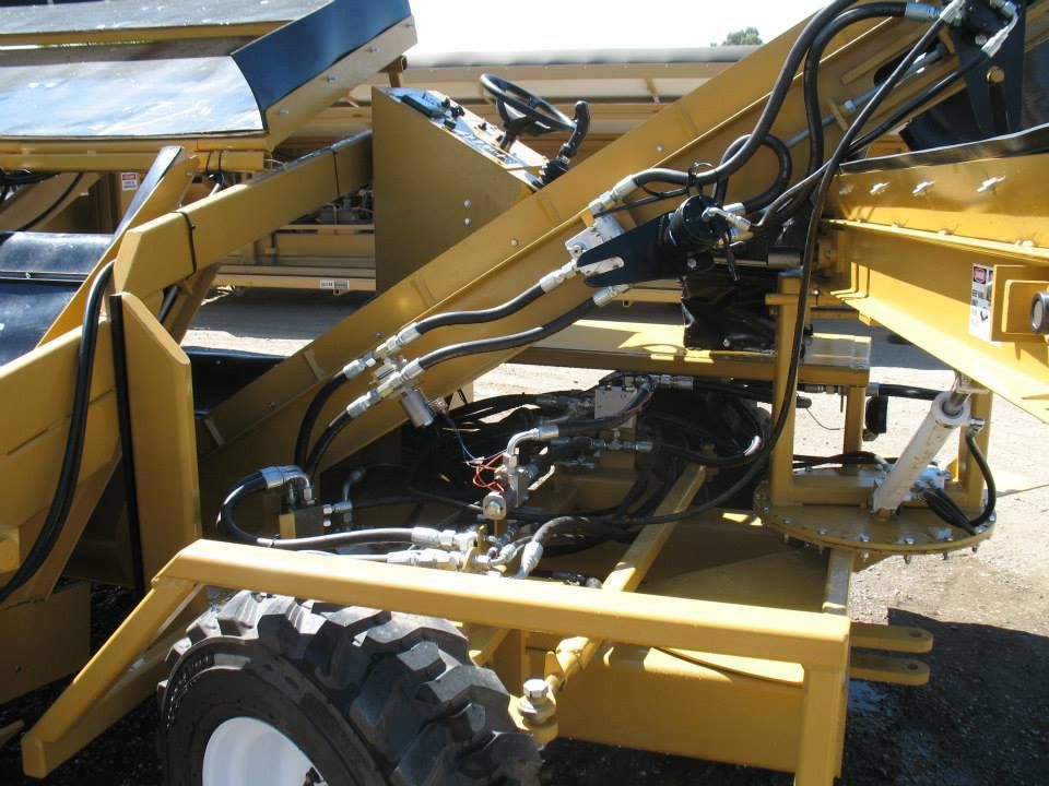 a yellow tractor with hydraulic hoses attached to it