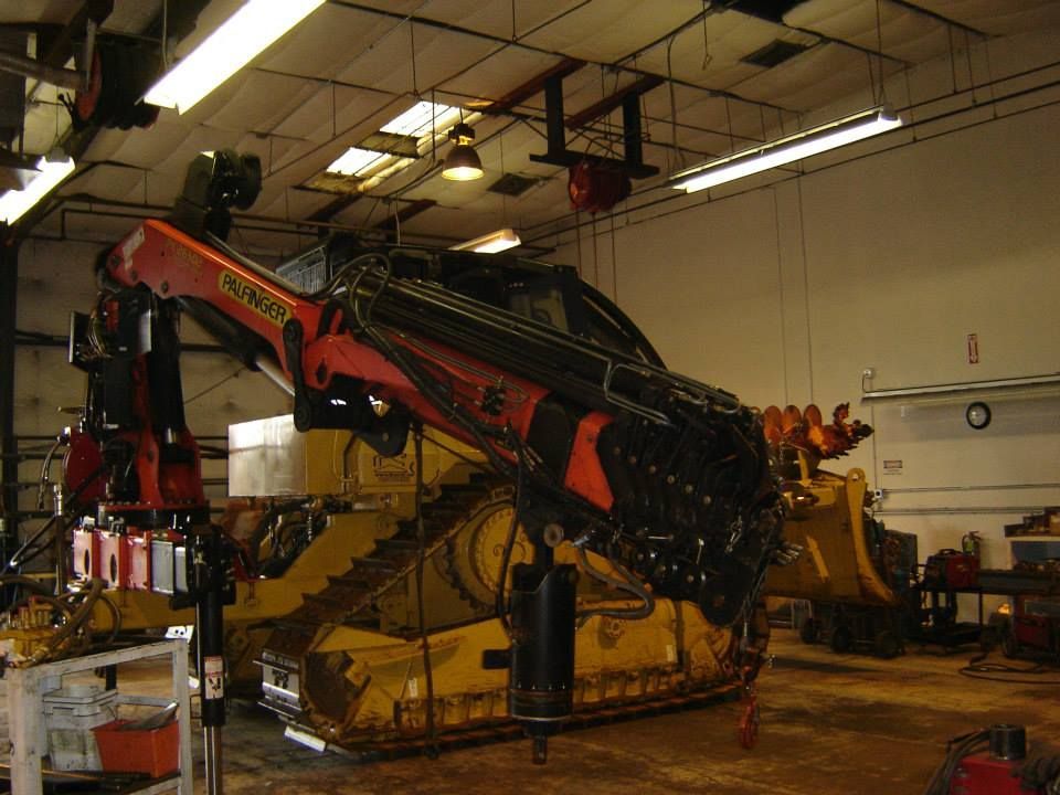 a large yellow bulldozer with a crane attached to it