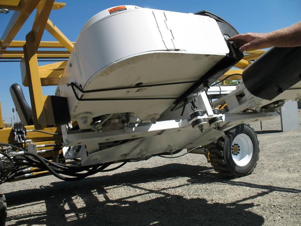 a white boat is being pulled by a yellow trailer