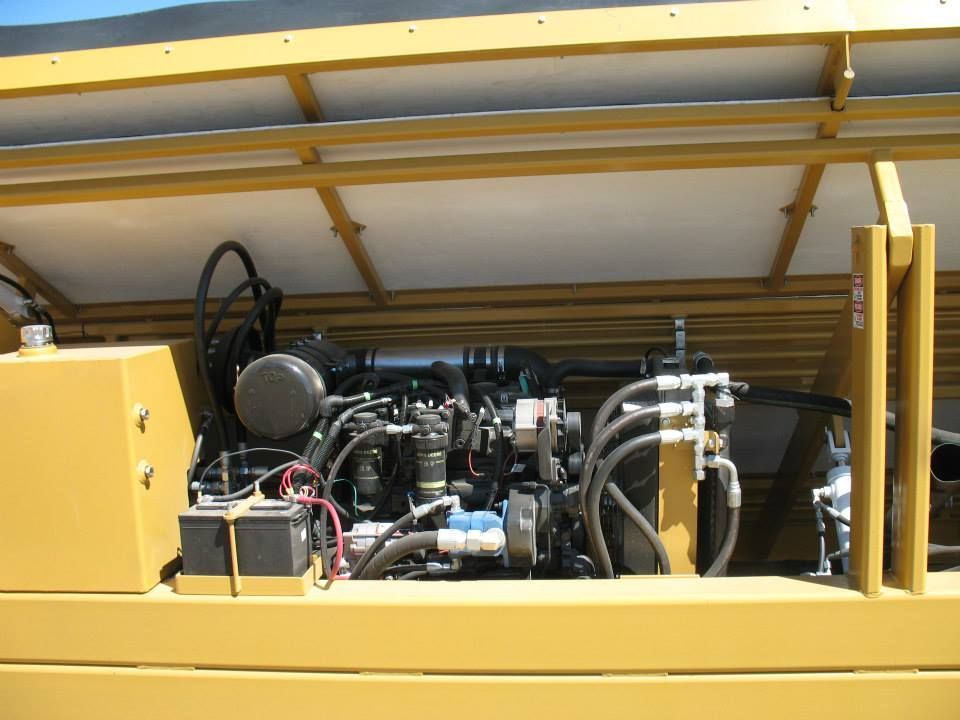 a close up of the engine of a yellow vehicle
