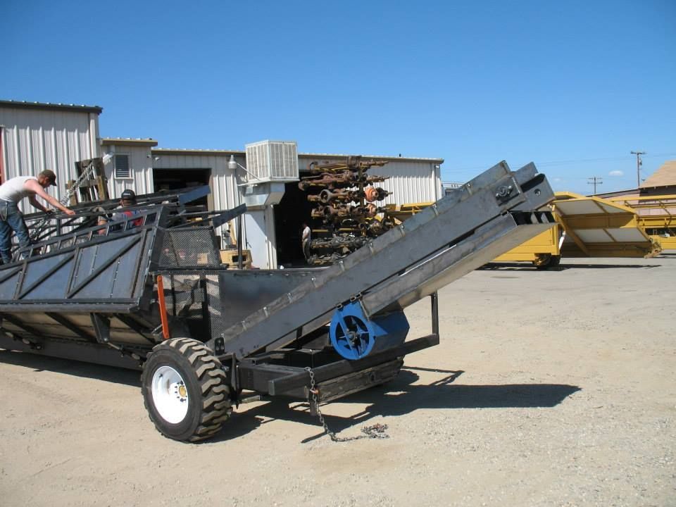 a man is working on a conveyor belt in a parking lot