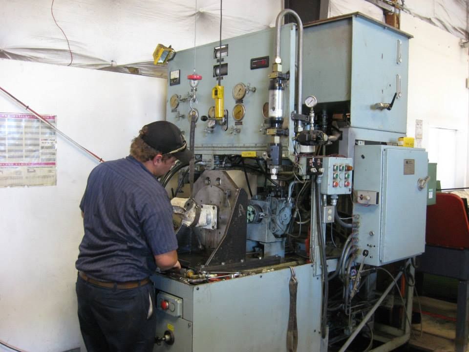 a man in a blue shirt is working on a machine