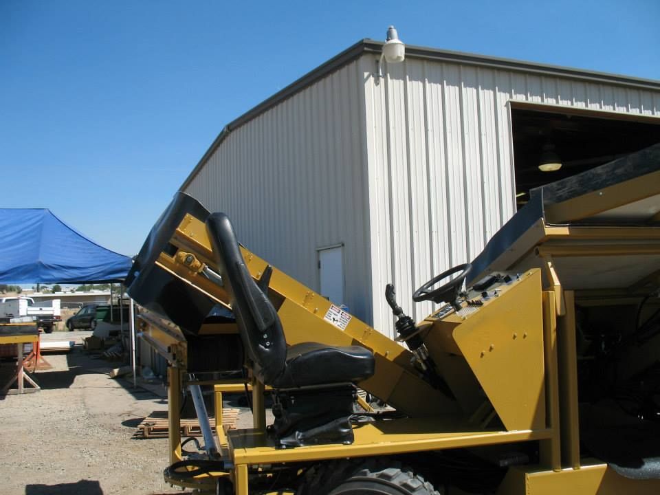 a yellow vehicle is parked in front of a white building