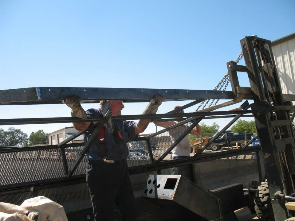 a man is carrying a piece of metal with the letter b on it