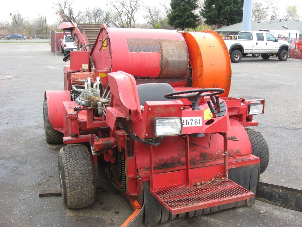 a red tractor with a license plate that says 29tri