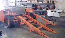 a tractor is being built in a garage .