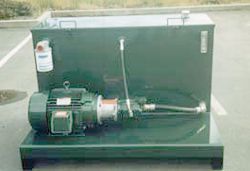 a green machine with a motor and a hose is sitting in a parking lot .