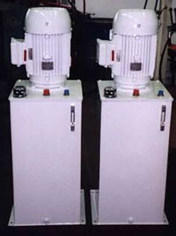 two white hydraulic pumps are sitting next to each other on a table .