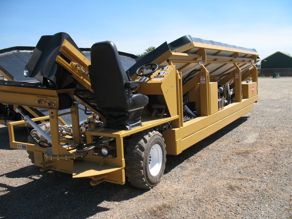 a yellow truck with black seats is parked in a dirt lot