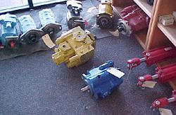 a bunch of hydraulic pumps are sitting on the floor in a room .