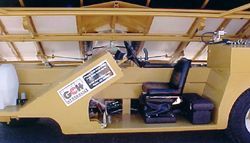 a model of a truck with a steering wheel and seats .