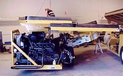 a man is working on a machine in a garage .