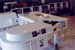 a white piano is sitting on top of a table in a room .
