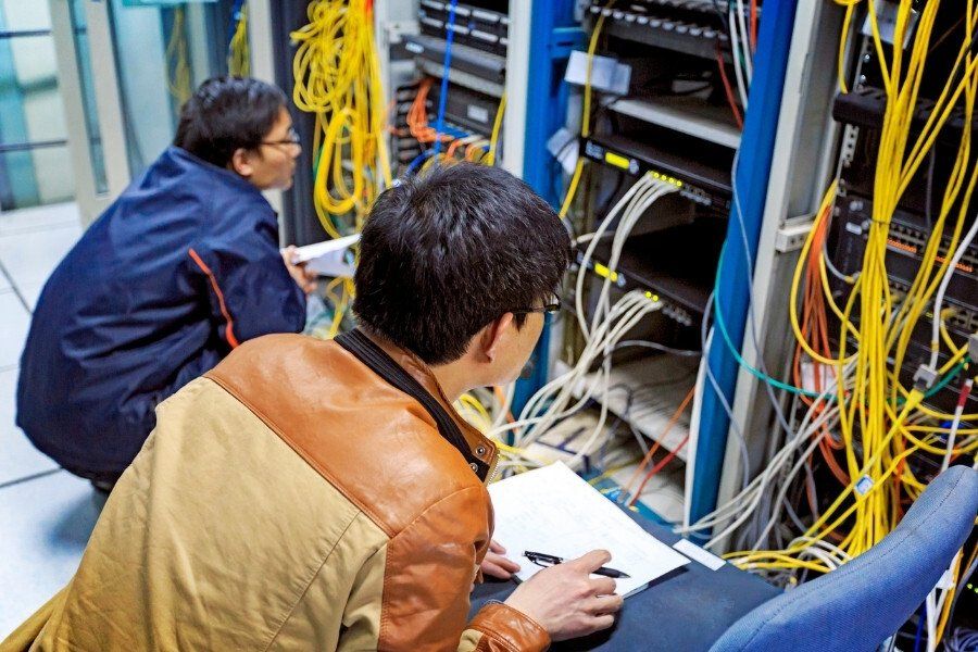 two men monitoring a ups system