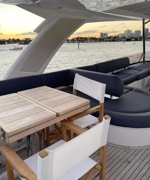 A boat with a table and chairs on the deck