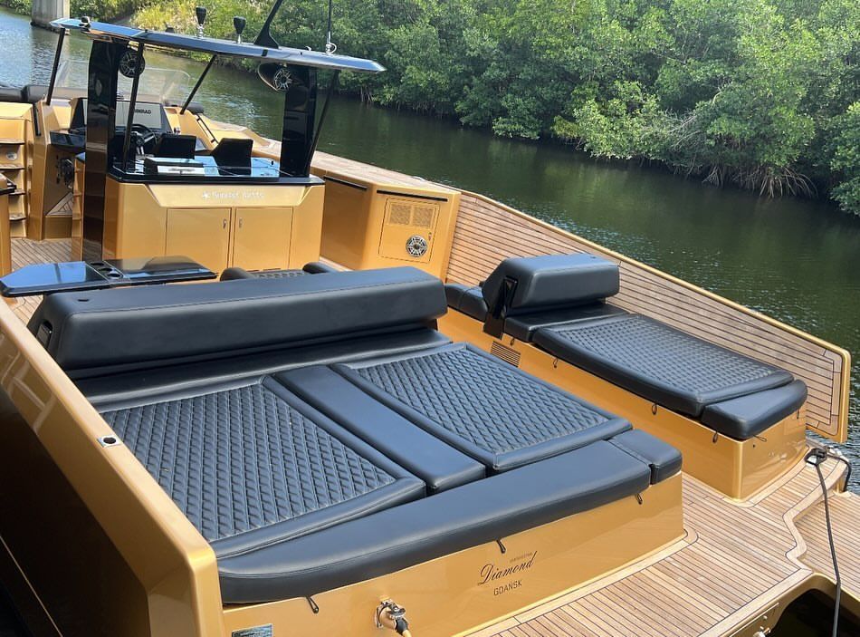 A boat is sitting on the water next to a river.