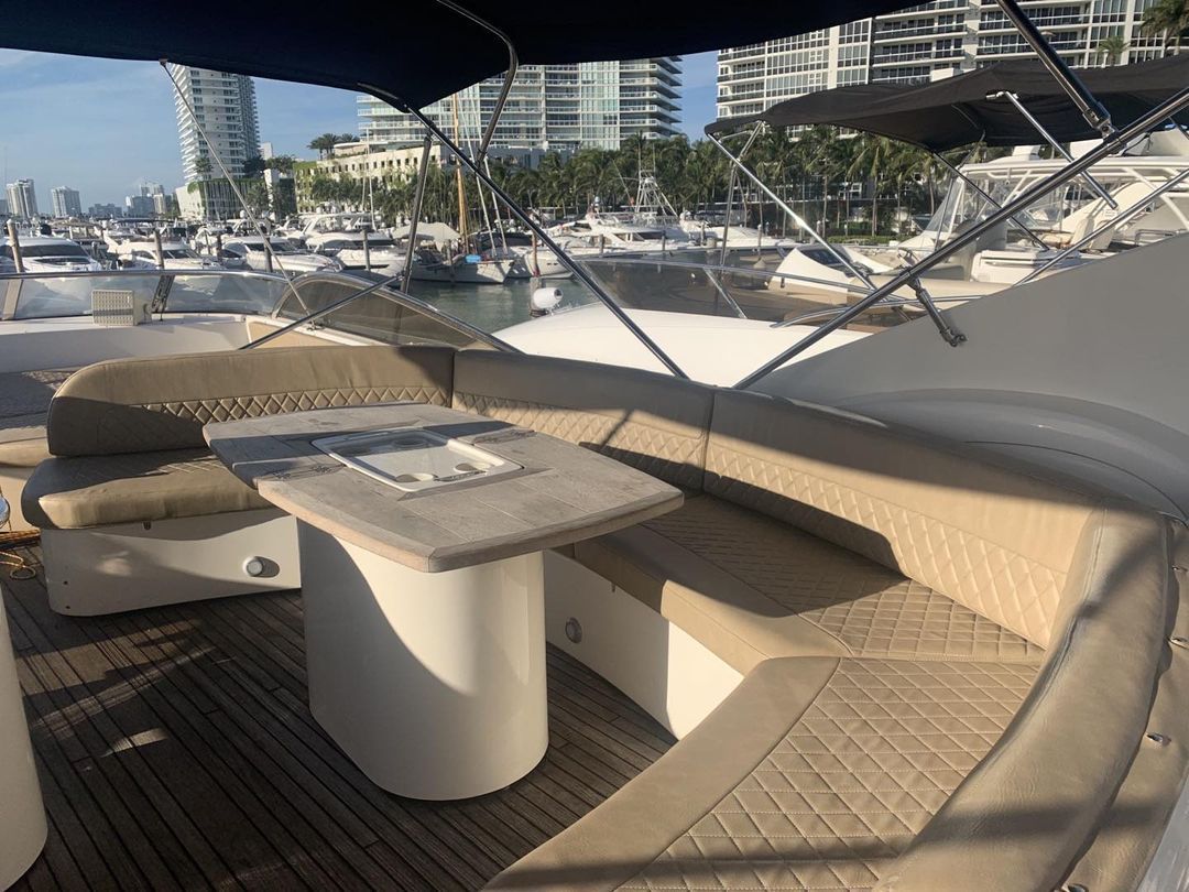 A boat with a table and benches on the deck.
