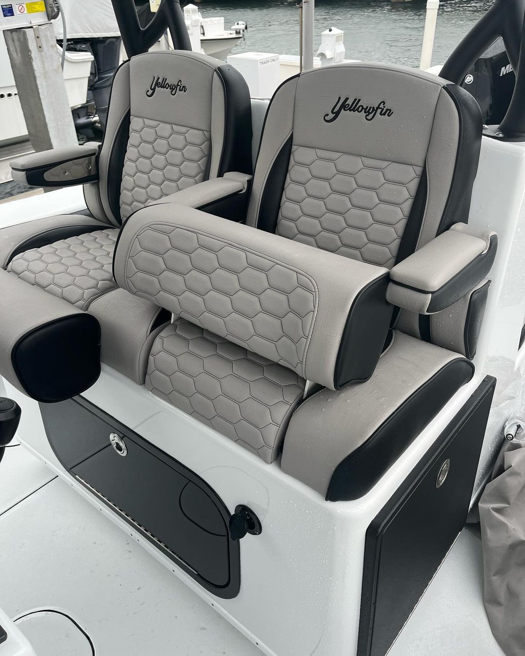 The seats on the boat are gray and black.