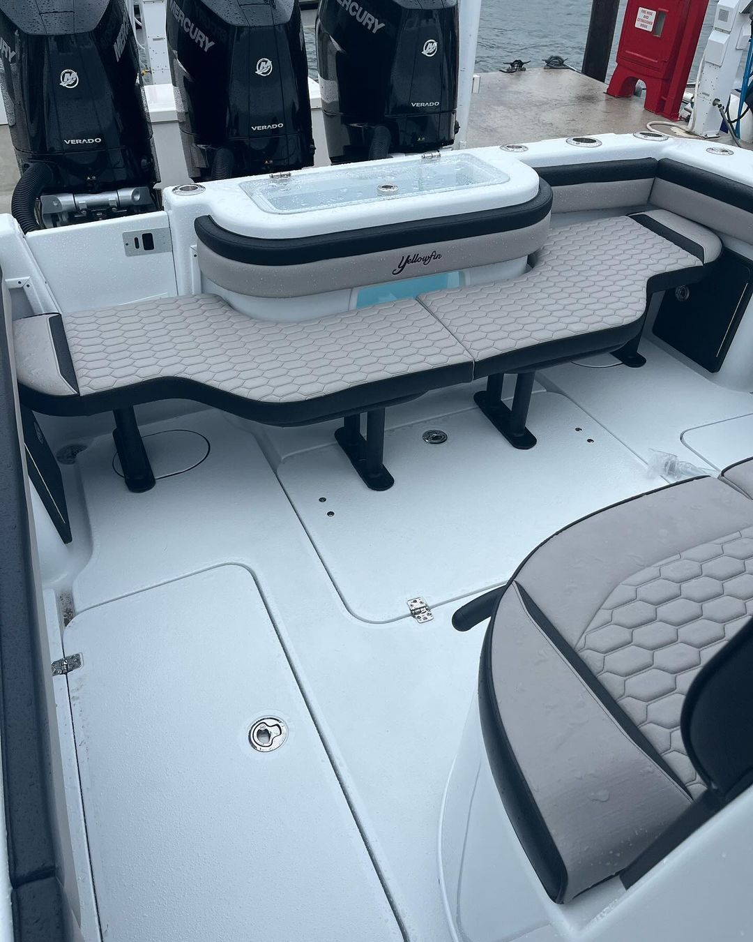 The back of a boat with a table and chairs on it.