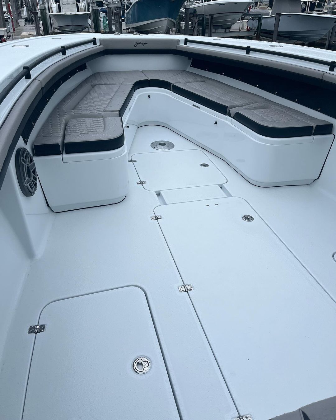 The inside of a white boat with a bench on the deck.
