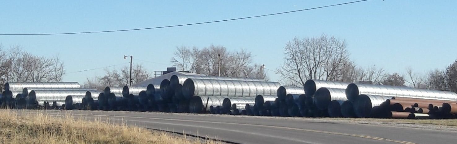 A bunch of tires are sitting on the side of the road — Odessa, MO — Continental Pipe Co.