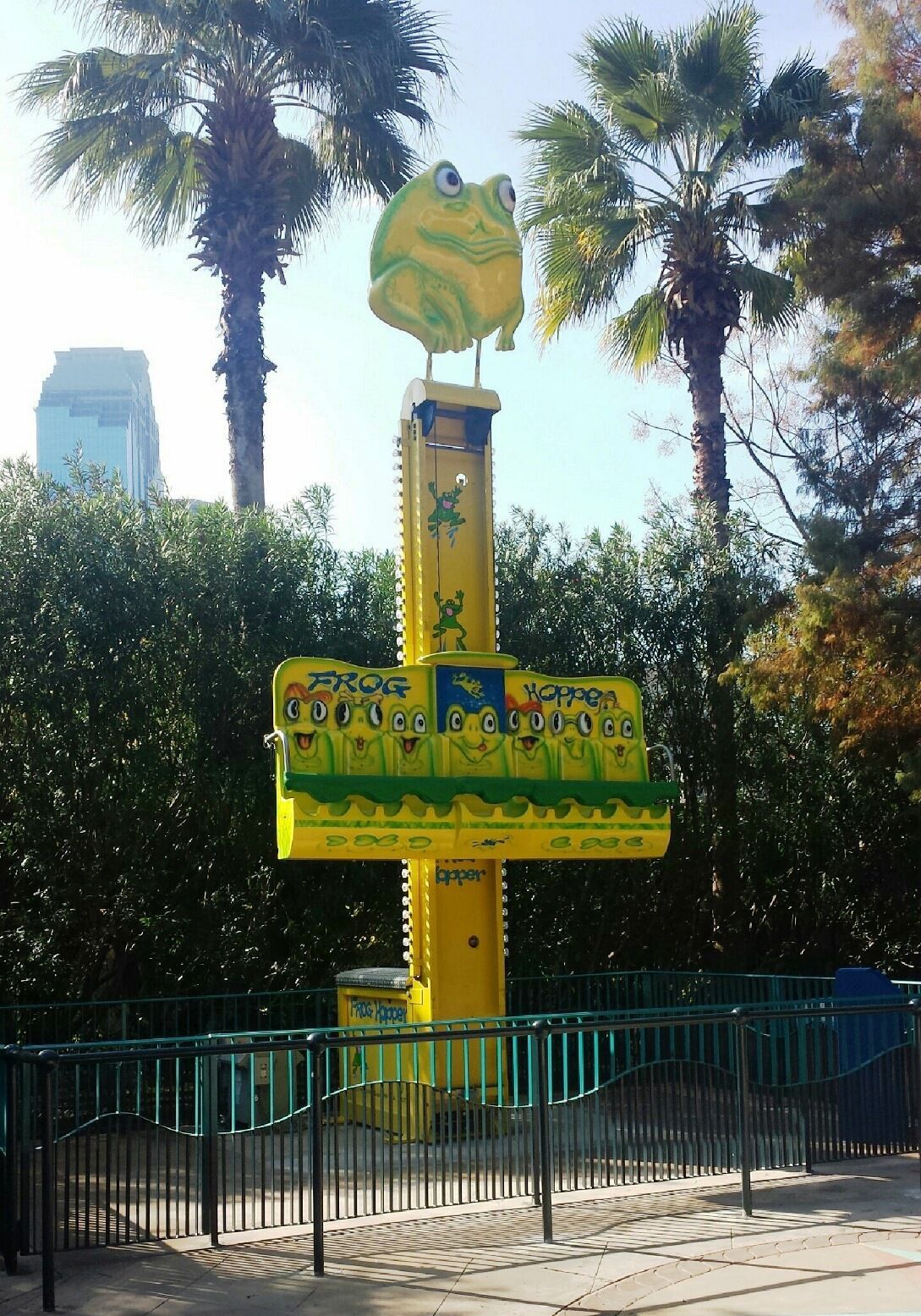 A yellow sign with a frog on top that says ' frog ' on it