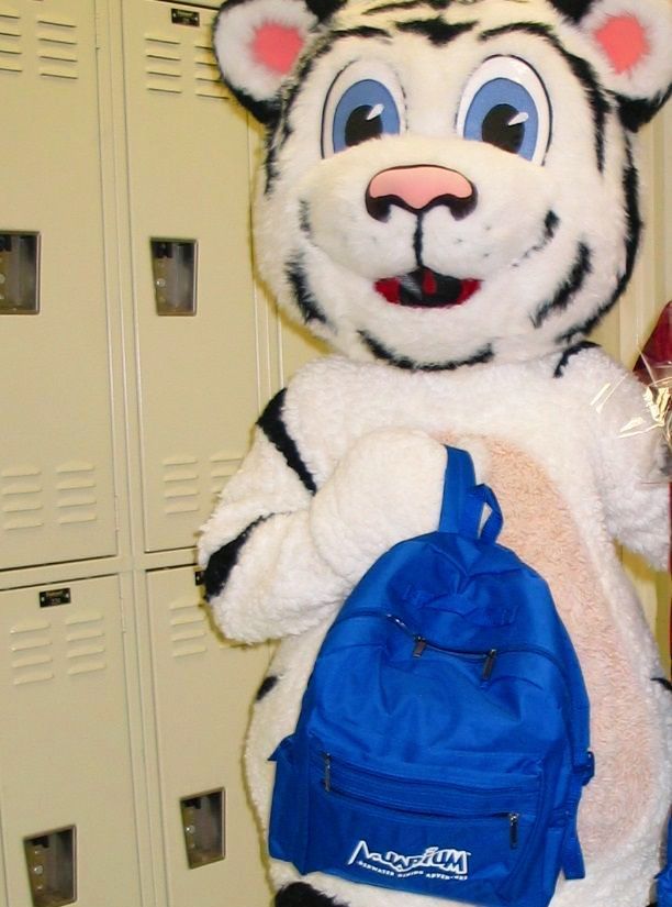 A mascot in a tiger costume is holding a blue backpack