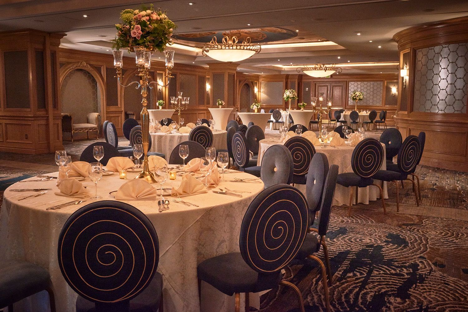 A large room with tables and chairs set up for a banquet