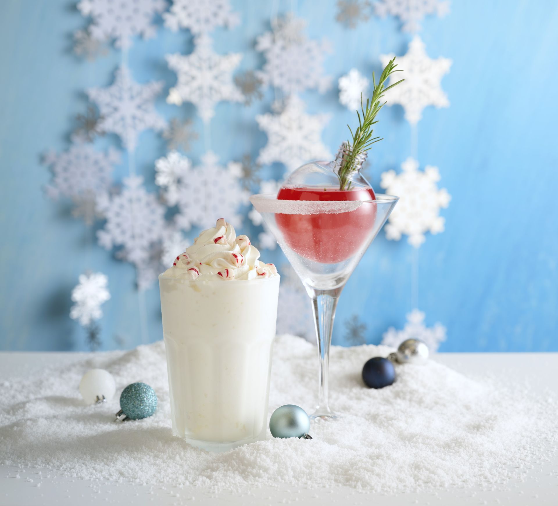 Pumpkin dessert on a white plate, garnished with berries and mint. Orange and black sprinkles.