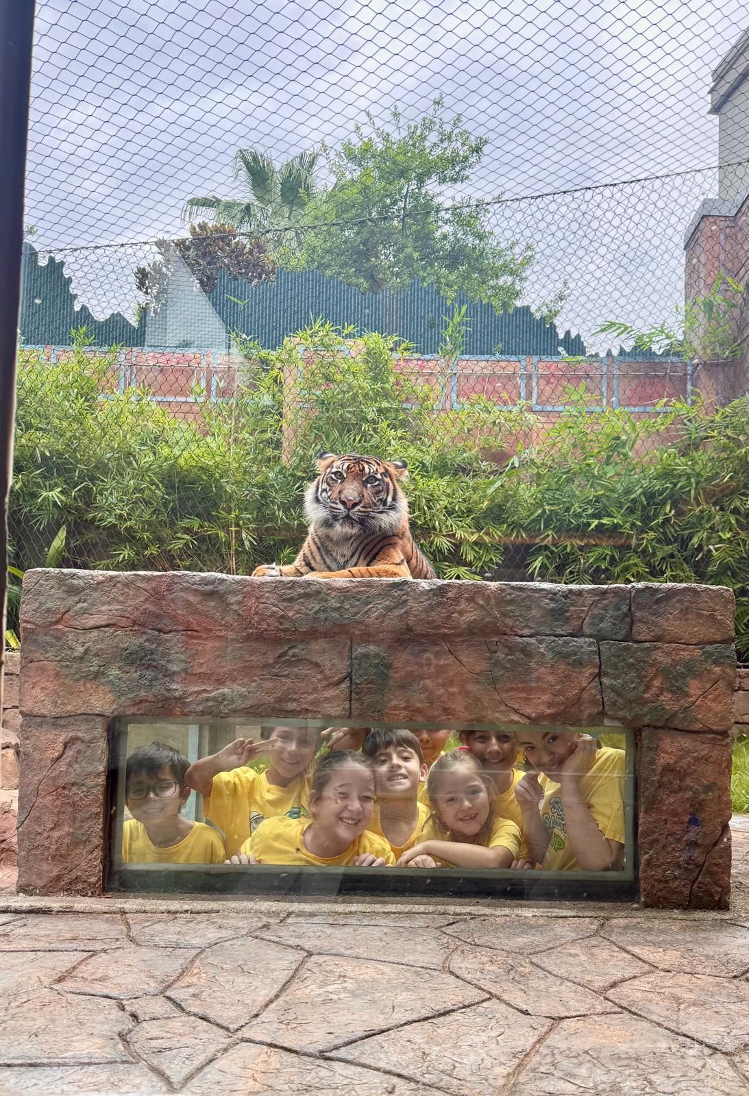 Three children are posing for a picture and one of them is wearing a shirt that says ' snoopy ' on it