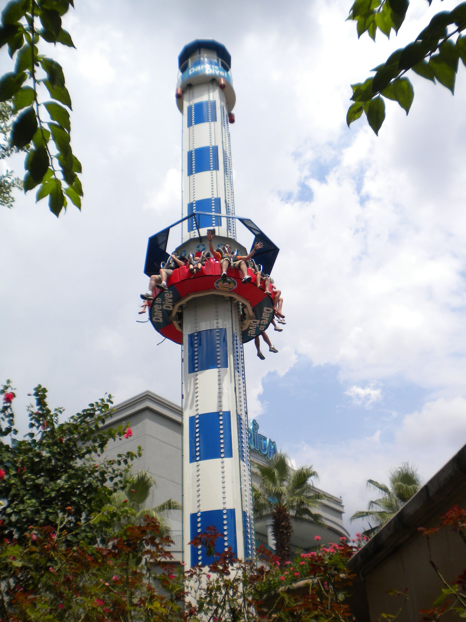A blue and white tower with people riding on it