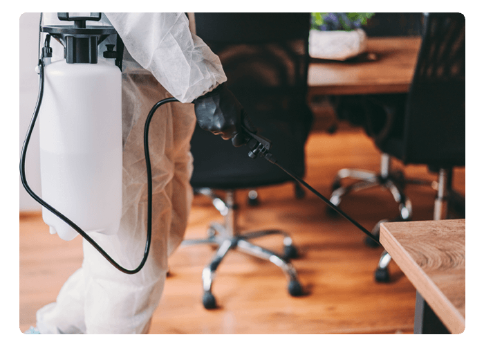 Man In Protective Suit and Face Mask Spraying for Disinfection in the Office — Northern Brisbane, QLD — JHS