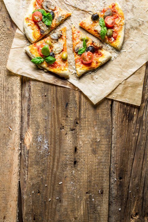 Fresh pizza on paper and old wooden table - Original Italian Pizza, Danville, PA