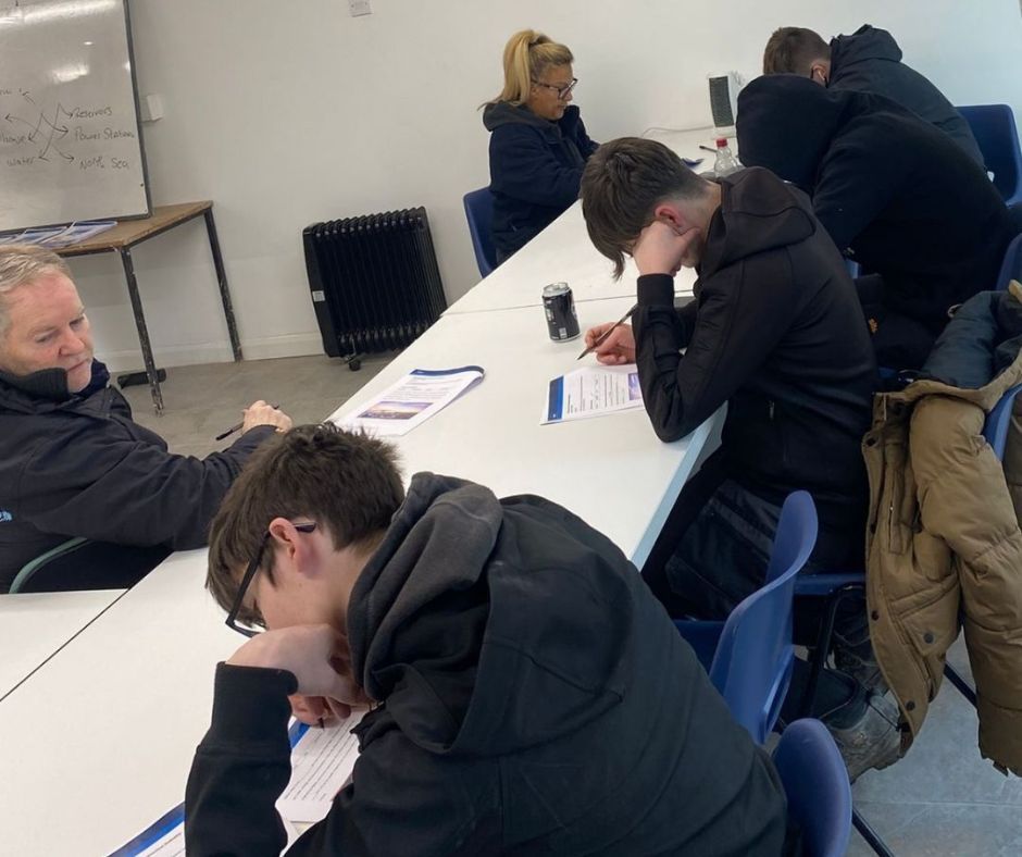 A few students are taking the CSCS health and safety test at Chameleon Skills.