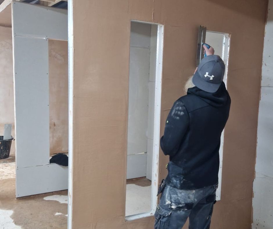 Beginner plastering training – a man learning hands-on plastering techniques at Chameleon Skills