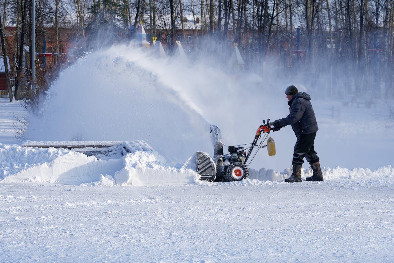Photo of a man clearing snow as a representation of commercial snow removal services by Facility Solutions