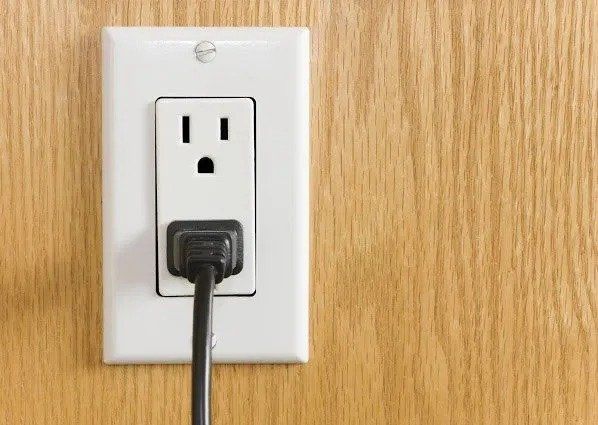 Electrical Plug On Wooden Wall — Fort Lauderdale, FL — Langer Electric Service Co.
