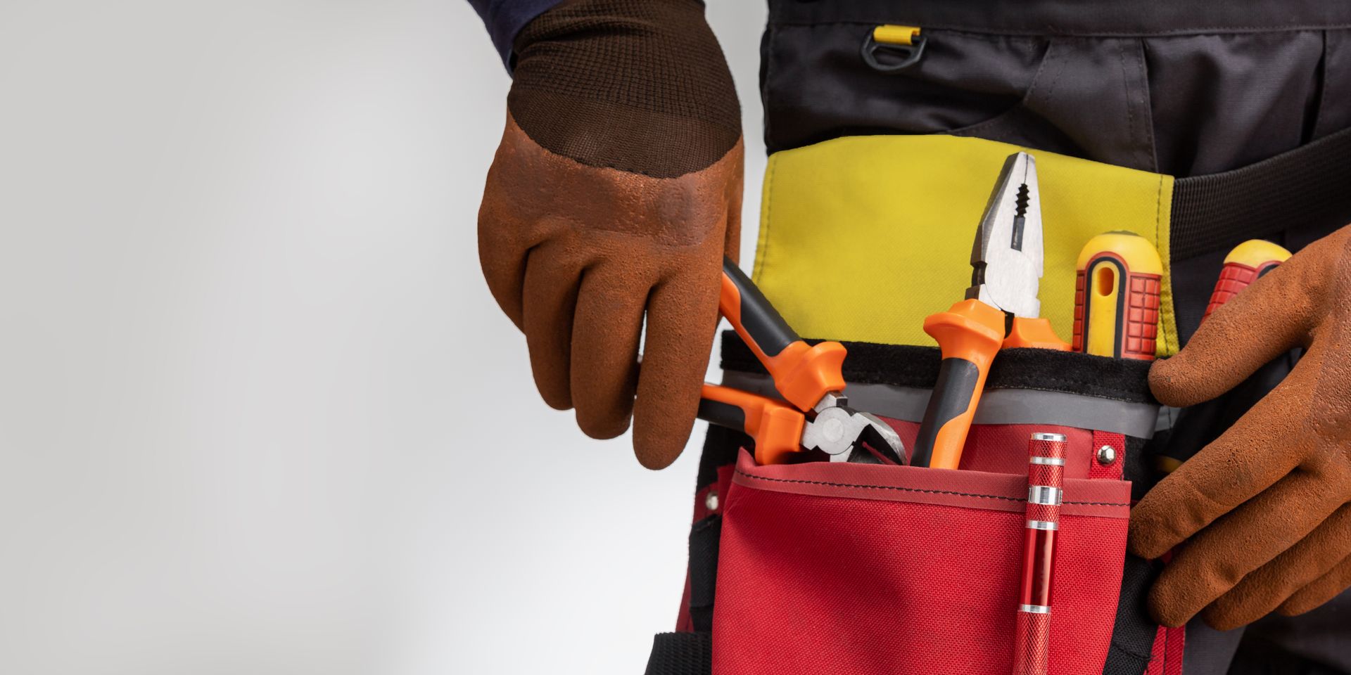 Close-up of tools belt on electrician worker.
