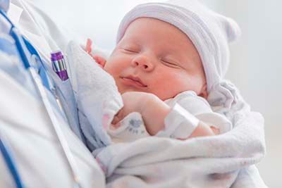 Baby sleeping in a doctors arms