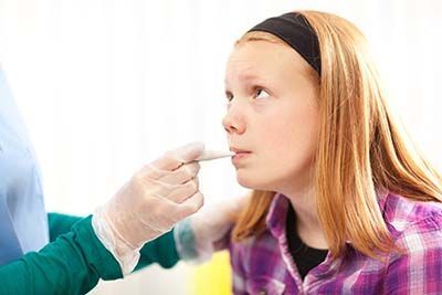 Girl taking her temperature